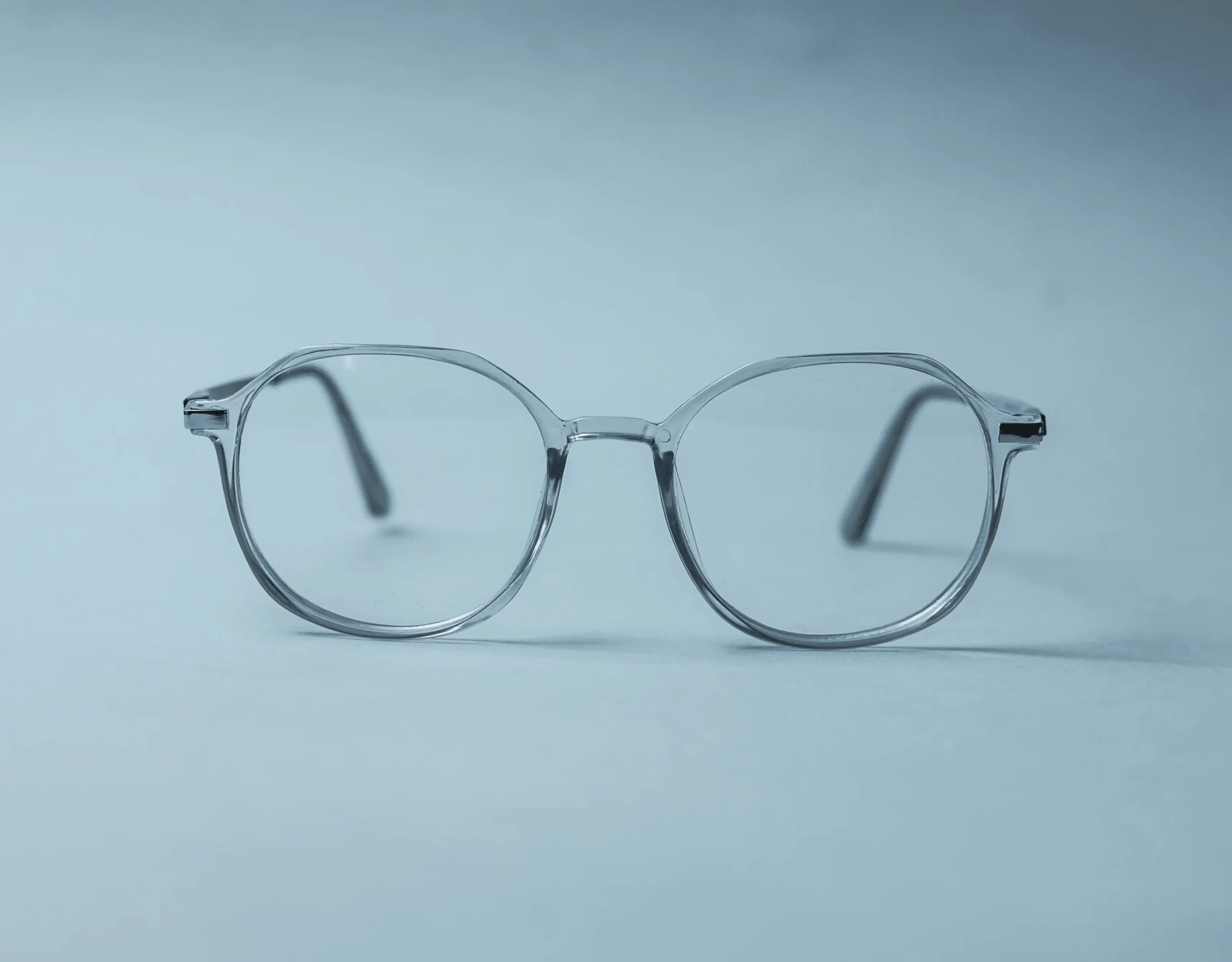 Clear eyeglasses resting on a light surface